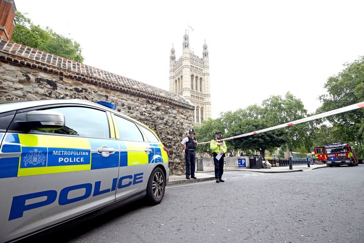 Police stand at the cordon in place near the Houses of Parliament, Westminster in central London.