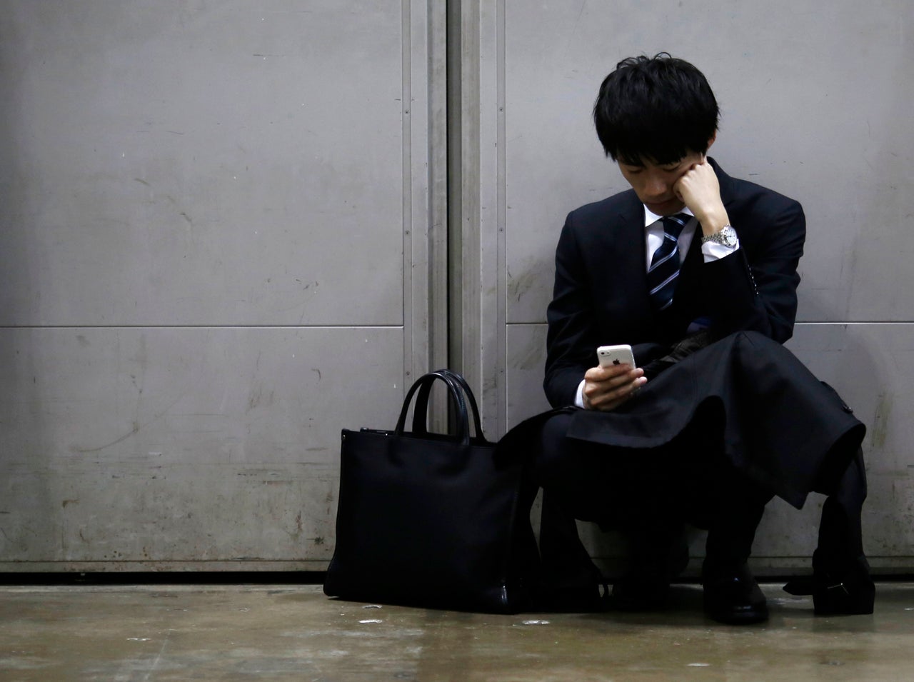 A job seeker looks at his cellphone during a job fair for graduates in Tokyo, 2015. Permanent jobs are harder to come by in Japan. Since the financial crisis in 2008, much of employment growth has been in fixed-term, part-time or temporary work.