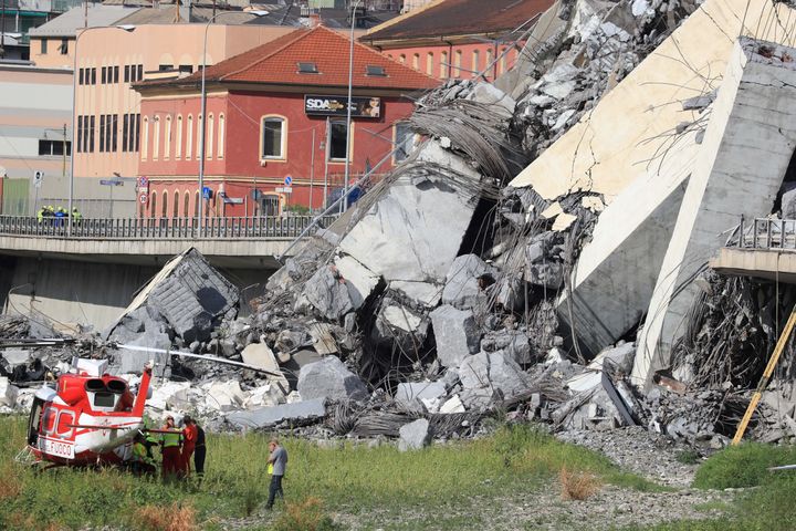 Rescuers work at the site where the Morandi motorway bridge collapsed in Genoa on August 14, 2018.