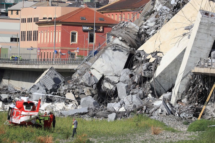 Rescuers work at the site where the Morandi motorway bridge collapsed in Genoa on August 14, 2018.