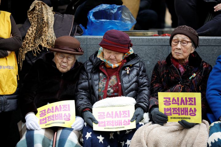 Former South Korean "comfort women" attend an anti-Japan rally on the day of the 98th anniversary of the Independence Movement Day in Seoul, South Korea, March 1, 2017. The women are holding signs demanding a formal apology and legal reparations from Japan. 