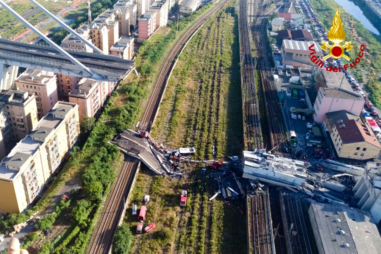 Italian firefighters rescue teams work among the rubble of the collapsed Morando highway bridge in Genoa .