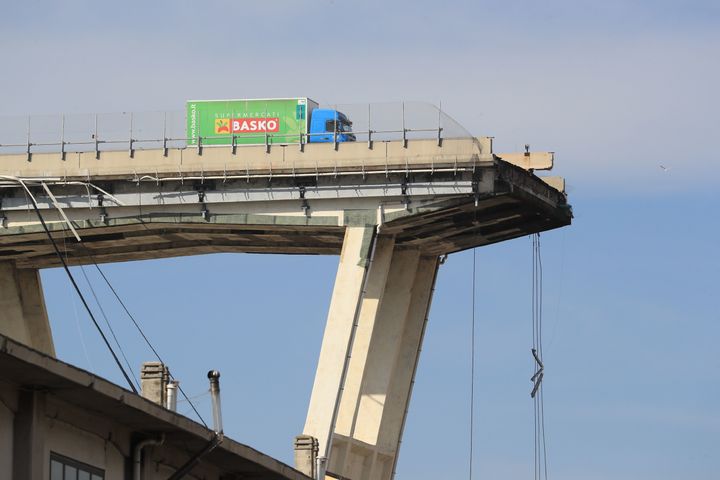 A lorry sits on the edge of the Morandi viaduct in Genoa, where a 260-foot span of highway broke away on Monday.