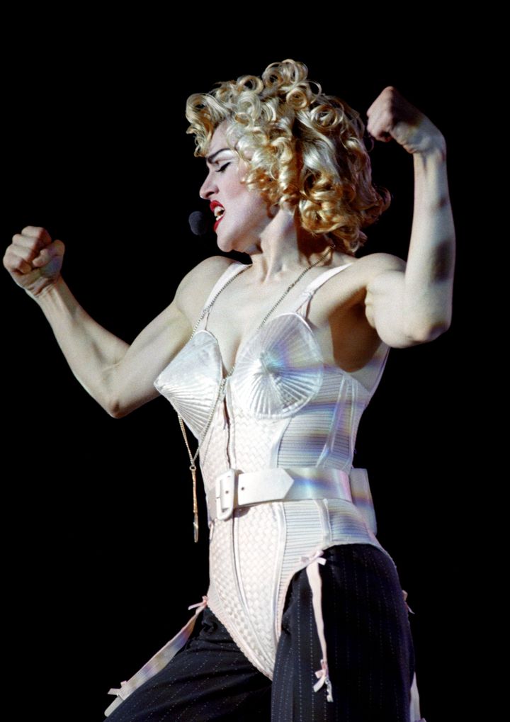 Madonna - in her iconic, Jean-Paul Gaultier-designed pointy bra - performs on stage at Wembley Stadium on her Blonde Ambition tour in 1990.