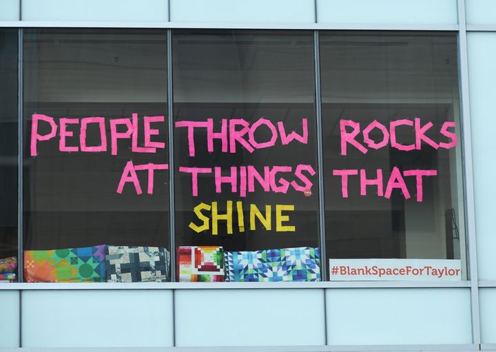 Workers in an office building taped up a message in support of pop singer Taylor Swift during her groping trial.