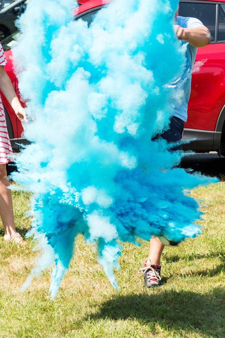 A dad-to-be kicks a soccer ball filled with blue powder to reveal that his baby will be a boy. 