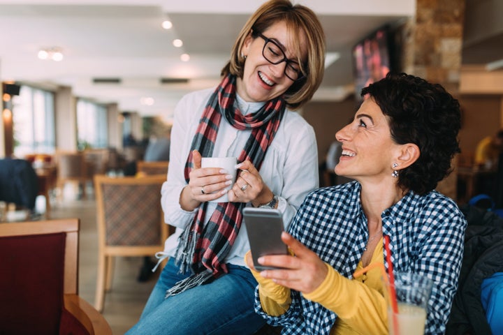 Photo of smiling women in coffee shop