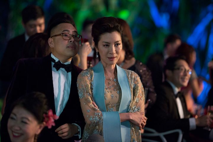 Oliver T'sien (Nico Santos) and Eleanor Young (Michelle Yeoh) at the wedding of Araminta Lee and Colin Khoo. Eleanor wore a regal, embellished gown by Elie Saab.