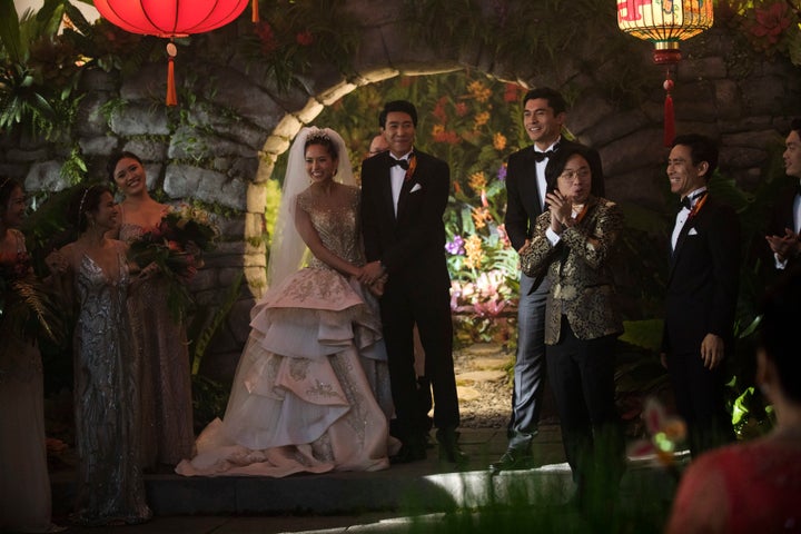 Araminta and Colin standing at their extravagant altar.