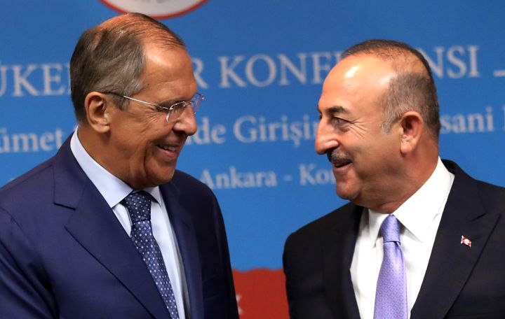 Turkey's Foreign Minister Mevlut Cavusoglu (R) and his Russian counterpart Sergei Lavrov smile during a joint press conference following their meeting in Ankara on August 14, 2018