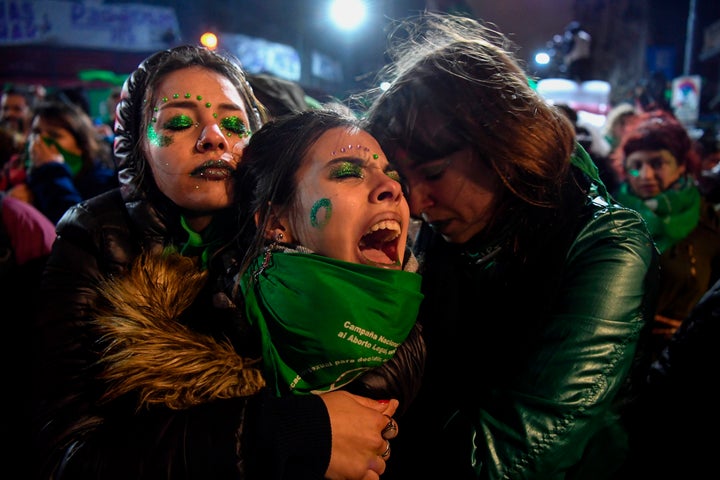 Activists in favor of the legalization of abortion comfort each other outside the National Congress in Buenos Aires on Aug. 9 after senators rejected an abortion bill.