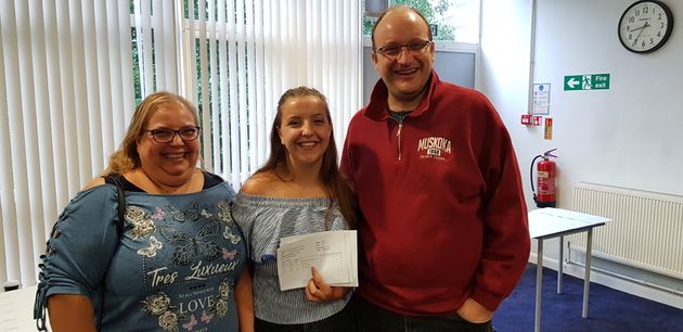 My husband and I with our daughter Hannah after she got her results at school