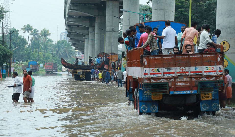 Commuters travel on a truck in the Ernakulam district of Kochi.