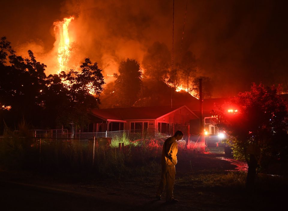 Firefighters defending houses from the blaze on 2 August.