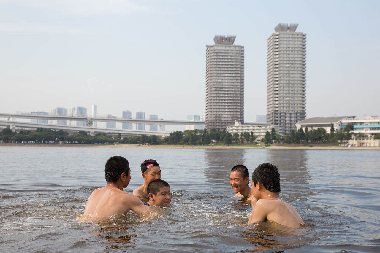 People cool off in a Tokyo park on 22 July.