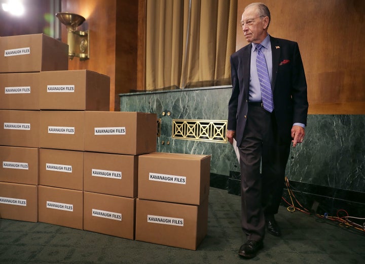 Senate Judiciary Committee Chairman Chuck Grassley (R-Iowa) walks out from behind a wall of empty boxes labeled 'Kavanaugh Files' during a news conference about Supreme Court nominee Judge Brett Kavanaugh.