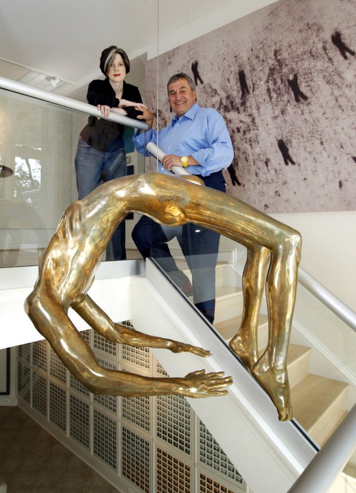 Tony Podesta and his now ex-wife Heather Podesta in front of The Arch of Hysteria by Louise Bourgeois, one of many expensive