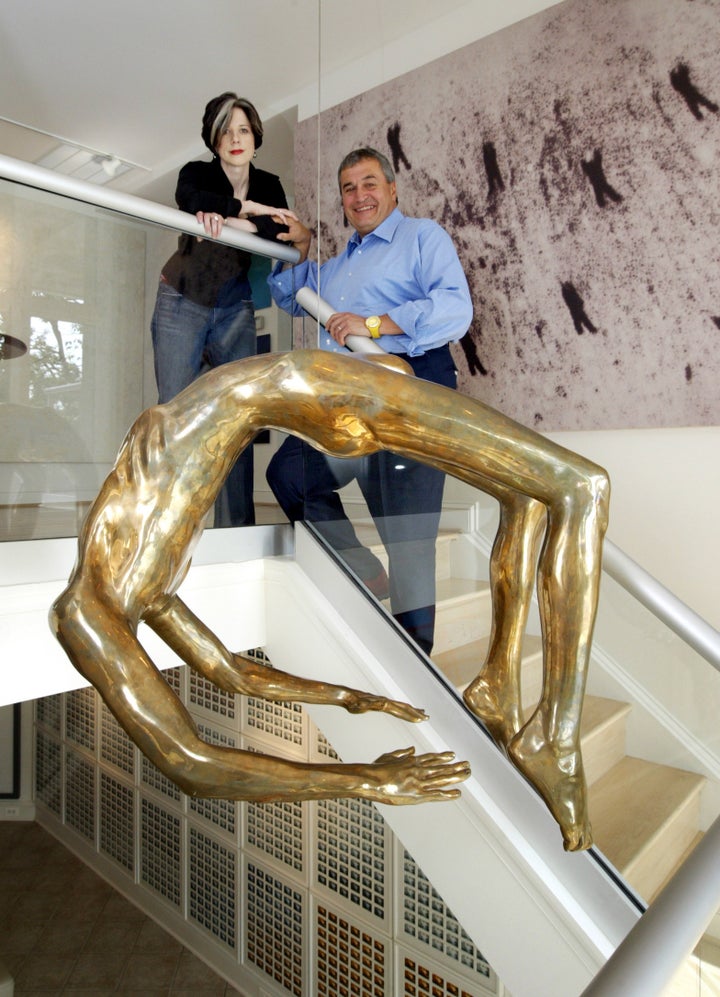 Tony Podesta and his now ex-wife Heather Podesta in front of The Arch of Hysteria by Louise Bourgeois, one of many expensive pieces of art purchased with Podesta's lobbying earnings.