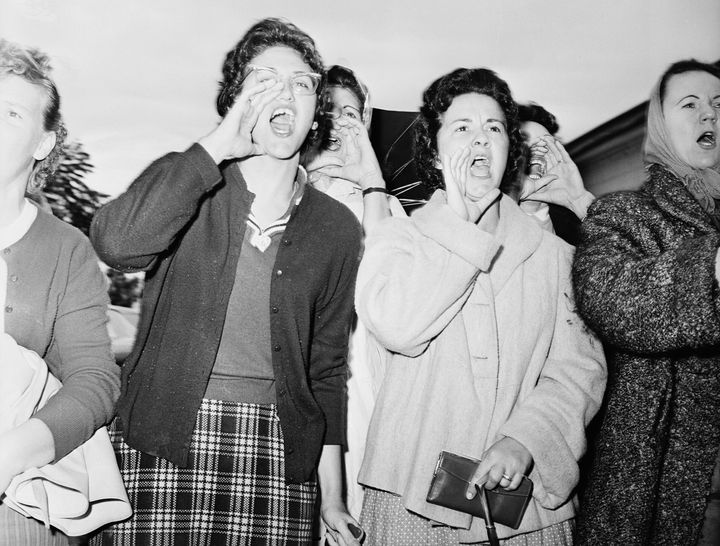 Mothers of white students at McDough Elementary in New Orleans scream as three six-year-old black girls enter the school on Nov. 18, 1960.