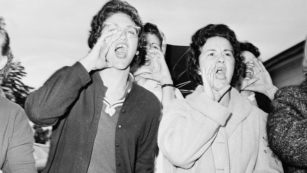 At McDough Elementary in New Orleans, Louisiana, mothers of white students scream as three six-year-old girls enter the school on their fifth day of classes. The New Orleans public school system was ordered shut down all next week for teachers' meetings after the attendance fell off by 1/3 following integration. Outbreaks of violence continued in the city with a reported score of arrests made, attributable to the school integration. November 18, 1960