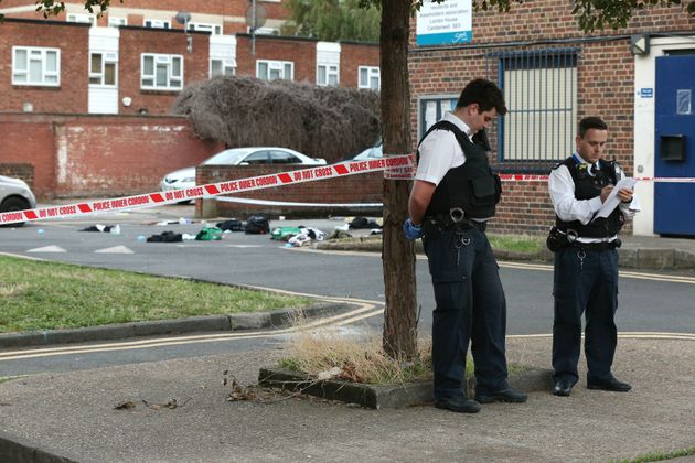 Police officers outside Landor House, Camberwell, London, after four people were taken to hospital with stab wounds. Five males have been arrested