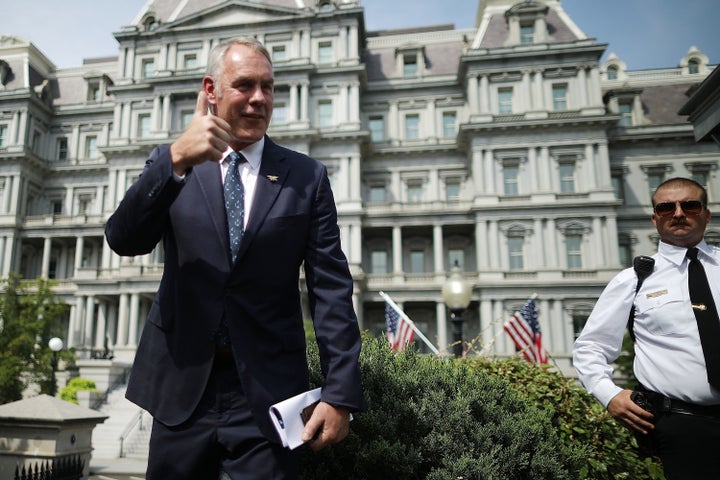 Interior Secretary Ryan Zinke talks to journalists outside the White House West Wing before attending a Cabinet meeting with President Donald Trump on Thursday. Zinke said the wildfires in the West are caused by mismanaged public lands and "environmental terrorist groups."