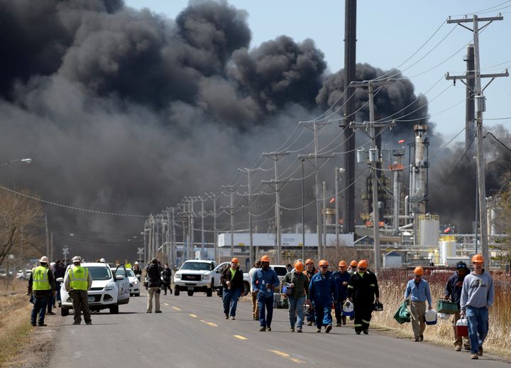 Workers evacuate from an explosion and fire at the Husky Energy oil refinery in Superior, Wisconsin on April 26, 2018.
