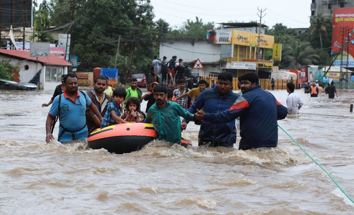 Indian volunteers and rescue personnel evacuate local residents in a boat in a residential area at Aluva in Ernakulam district, in the Indian state of Kerala on Aug. 17.