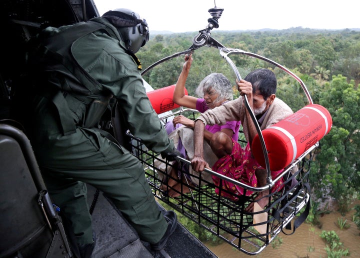 People are airlifted by the Indian Navy soldiers during a rescue operation at a flooded area in the southern state of Kerala, India, Aug. 17, 2018.