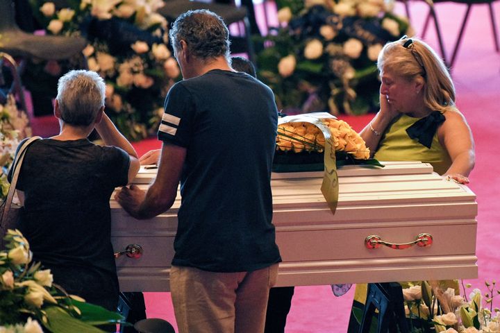 Relatives mourn near the coffins of some of the victims of the collapsed Morandi highway bridge on Saturday.