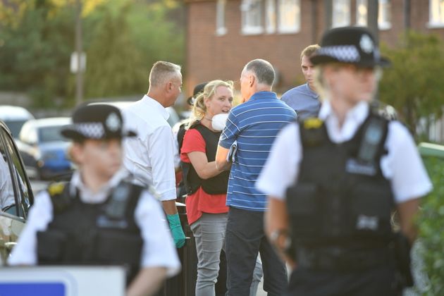 Police talk to residents in Adderley Gardens, Greenwich, south-east London, following the attack.