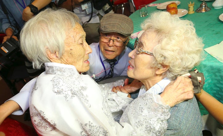 South Koreans Jo Hye-do (R), 86, and Jo Do-jae (C), 75, meet their North Korean sister Jo Soon Do (L), 89, during a separated