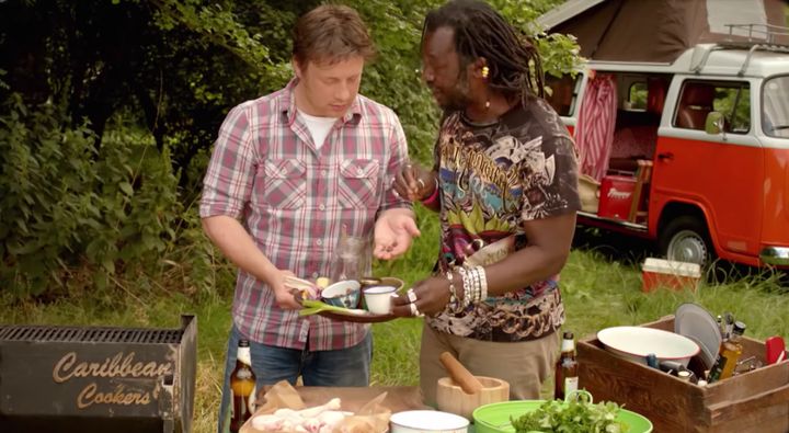 Jamie Oliver being taught about jerk marinade by Levi Roots in 2016