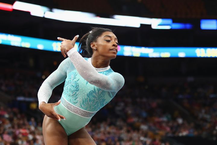 Simone Biles performs in a teal outfit during the floor exercise on Aug. 19.