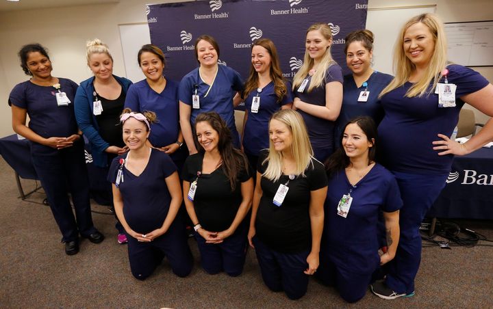 Twelve of the 16 pregnant nurses pose for a photograph after a press conference on Aug. 17, 2018.