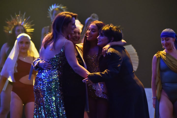 The four hug each other at the end of the performance.