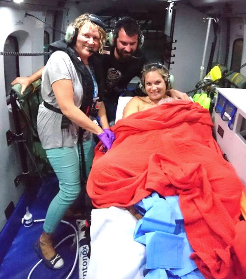 Alicia MacDonald, right, gave birth to baby Torran inside an airborne helicopter over the county of Cornwall, in southwest England, on Saturday night.
