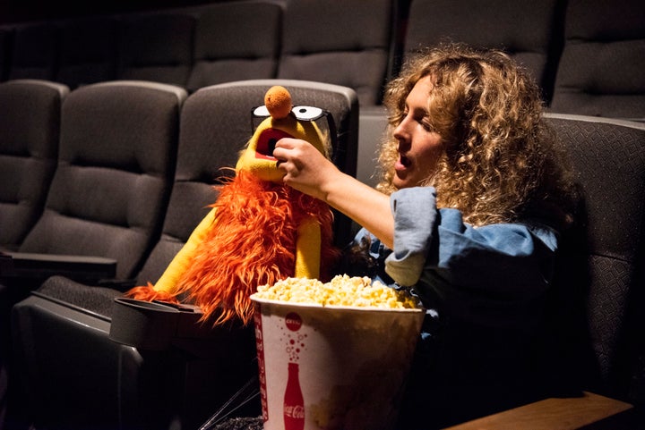 The author shares popcorn with her Puppet Boyfriend at a screening of "The Happytime Murders."