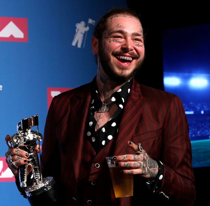 Post Malone poses backstage with his Song of the Year award for "Rockstar" during Monday Night's MTV Video Music Awards in New York.