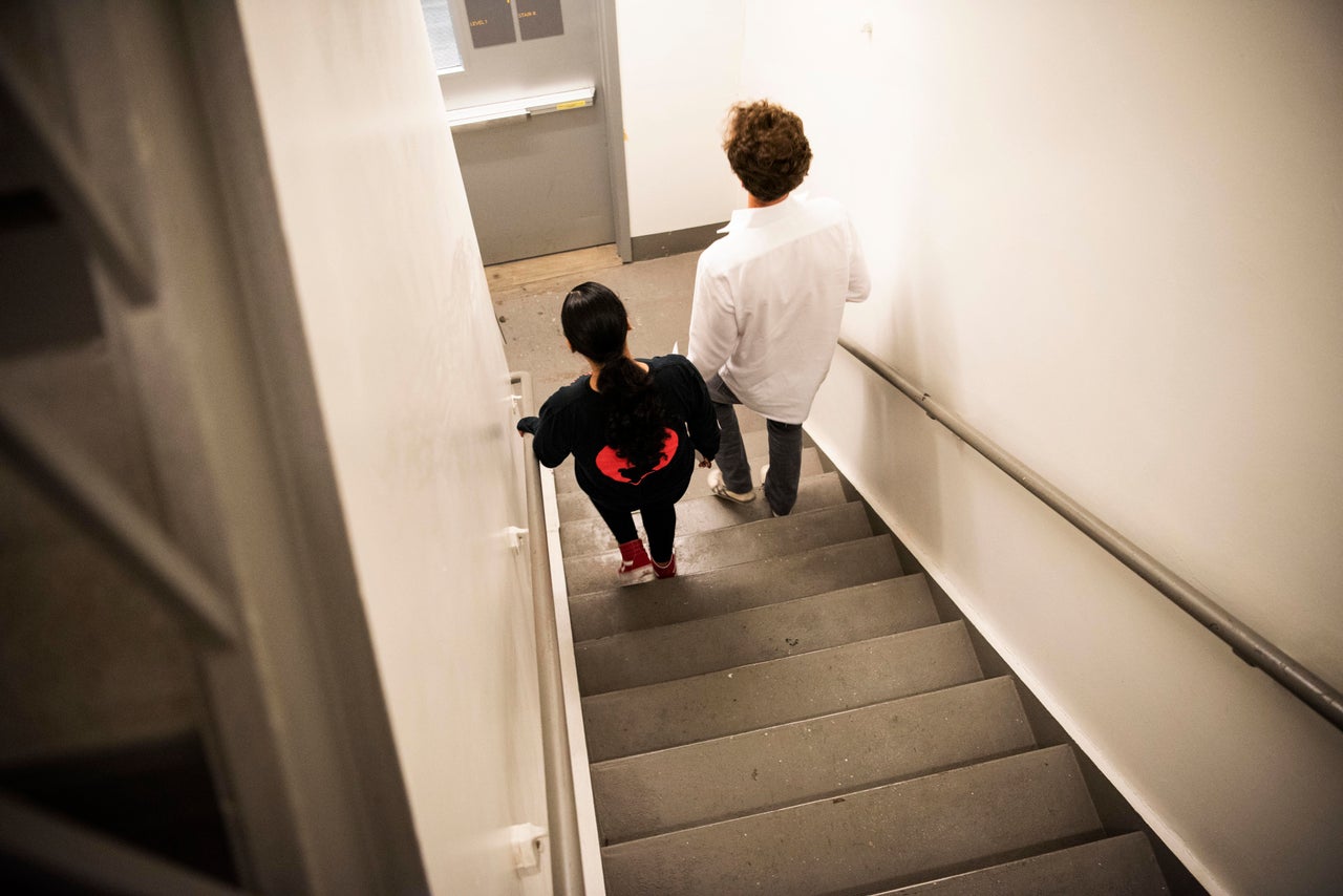 Deena walks with Gui Stampur, deputy executive director of the Safe Passage Project.