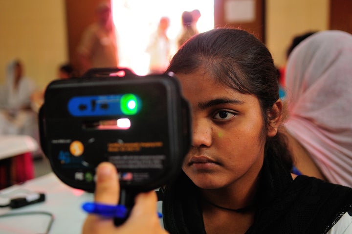 A woman gets screened for an Aadhaar card.