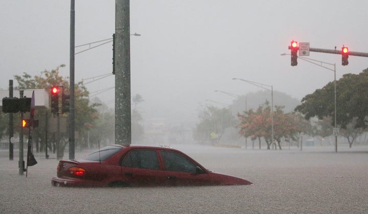 A car is partially submerged in floodwaters from Hurricane Lane rainfall on the Big Island in Hilo, Hawaii, on Thursday.