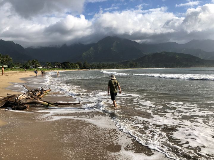 People walked along a calm Hanalei Beach on Wednesday as Hurricane Lane approached Kauai, Hawaii.