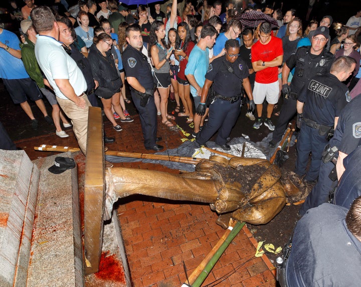 Police and protesters surround the toppled statue of a Confederate soldier nicknamed Silent Sam on the University of North Carolina campus in Chapel Hill. 