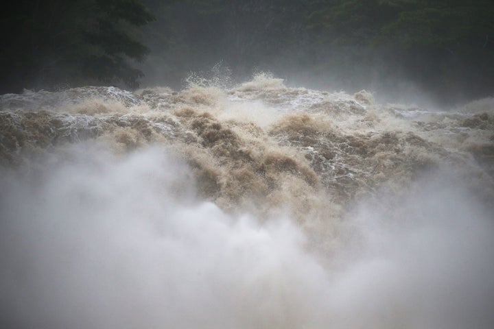 The typically-calm Wailuku River swelled with raging rain water.