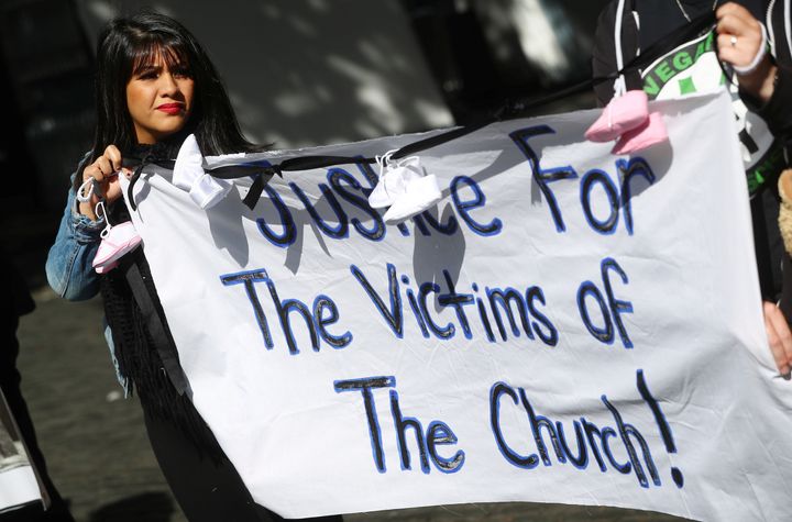 Protesters hold banners during a demonstration against clerical sex abuse, in Dublin, Ireland August 25, 2018.