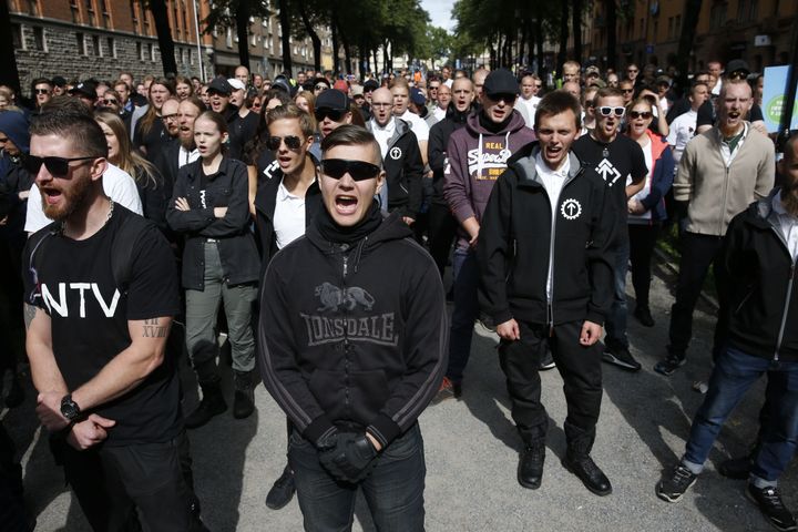 Supporters of the neo-Nazi Nordic Resistance Movement chant slogans during a demonstration at the Kungsholmstorg square in Stockholm on Aug. 25.
