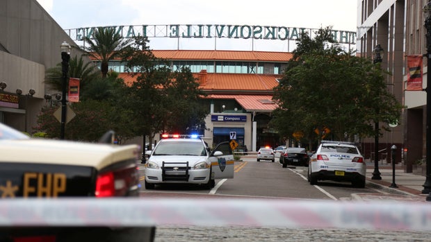 Police officers cordon off a street outside The Jacksonville Landing after a shooting during a video game tournament in Jacksonville, Florida August 26, 2018.  REUTERS/Joey Roulette