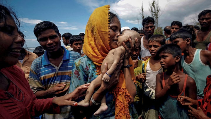 Hamida, a Rohingya refugee woman, weeps as she holds her 40-day-old son after he died as their boat capsized before arriving on shore in Shah Porir Dwip, Teknaf, Bangladesh, on September 14, 2017. Reuters won Pulitzer Prizes for covering the attacks in Myanmar.