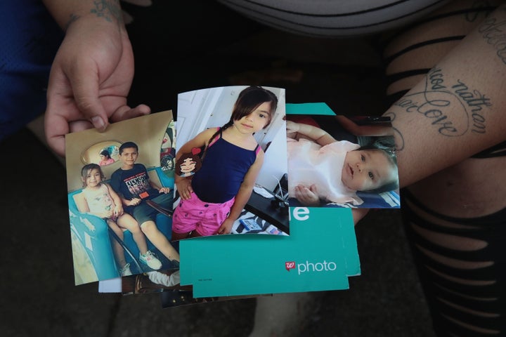 Amber Ayala looks through pictures of her brothers and sisters who were killed in an early-morning fire in the Little Village